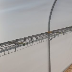Closeup view of side railing from interior of domestic greenhouse