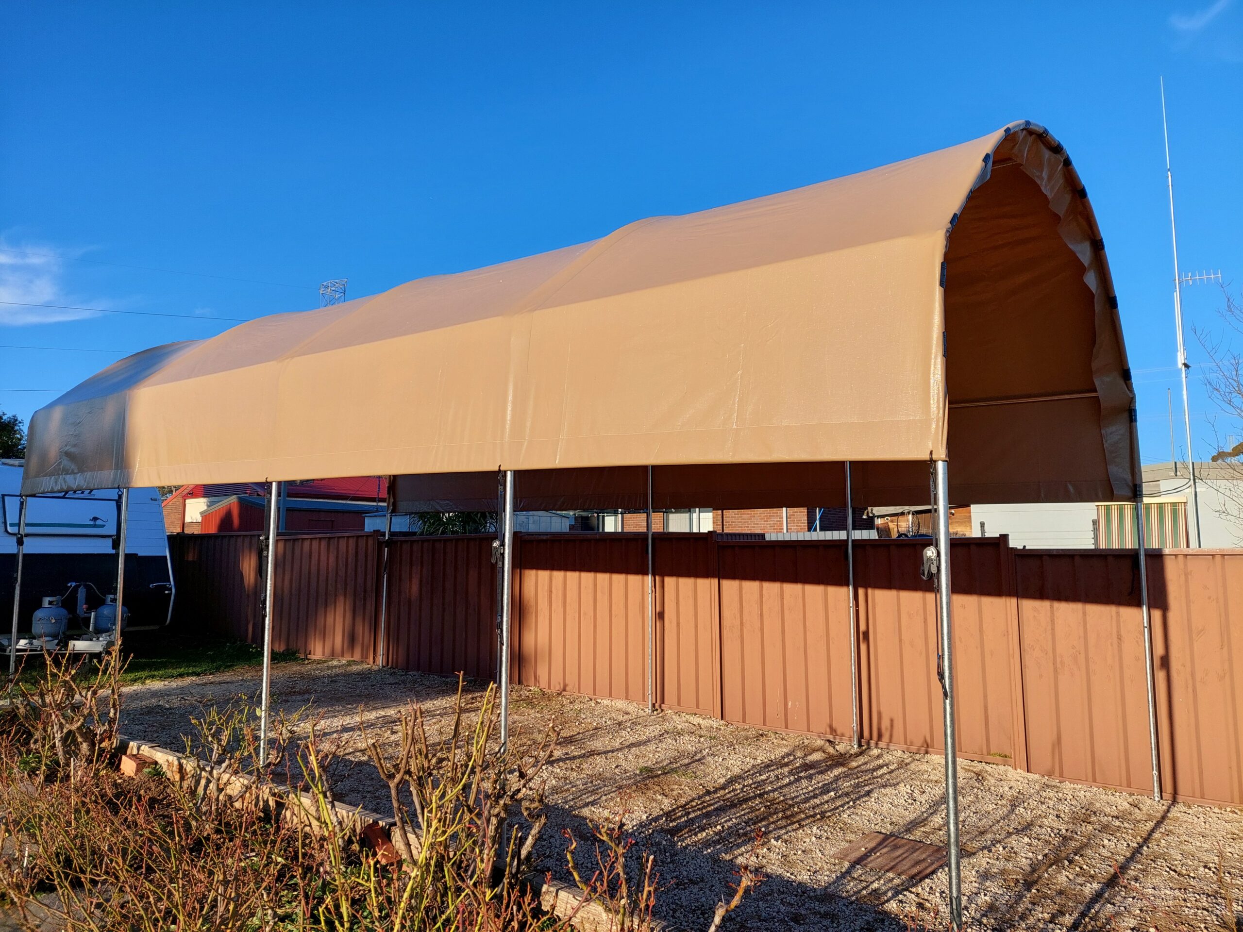 Large caravan and boat shelter with a dark beige coloured top