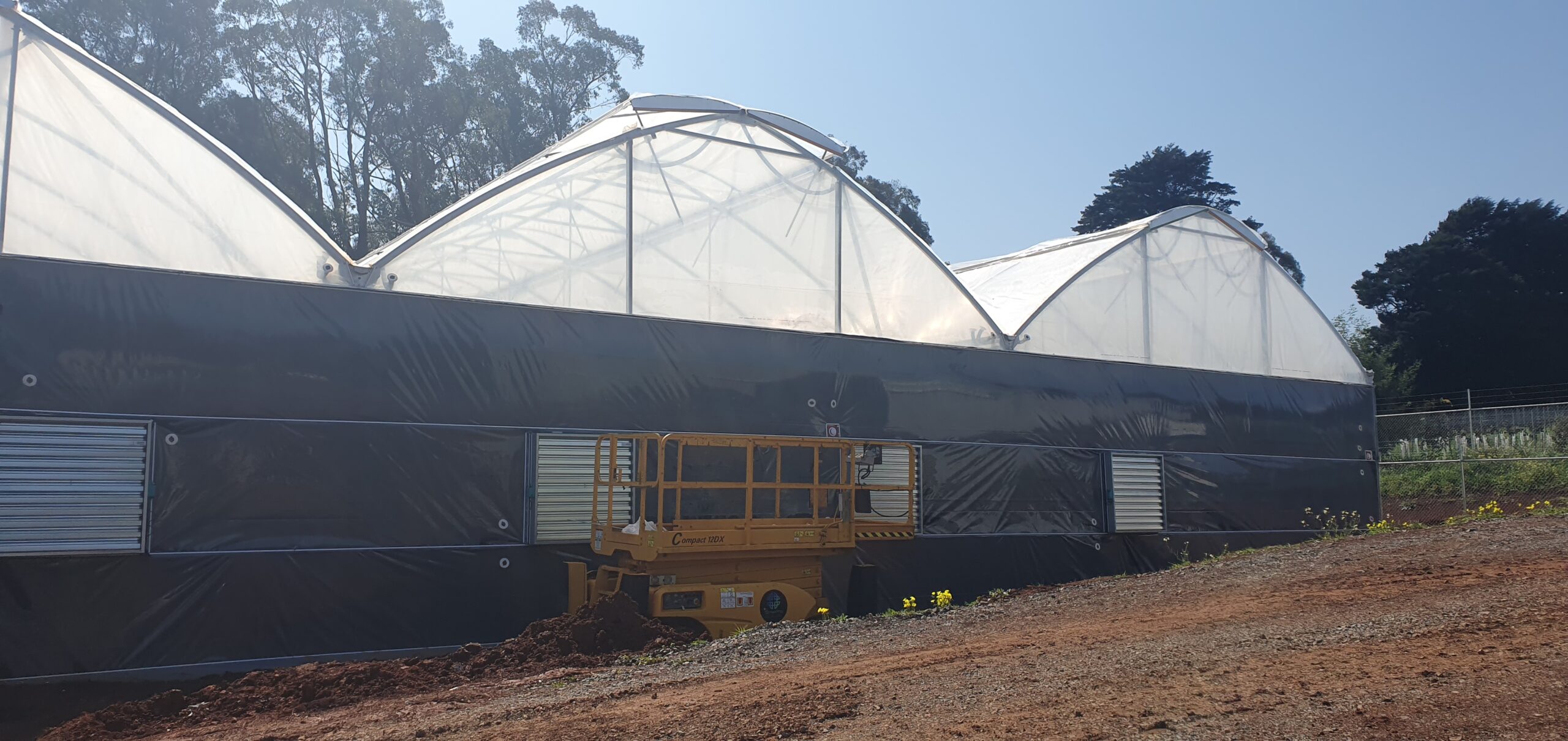 Exterior of medicinal structure - blue sky - dirt road