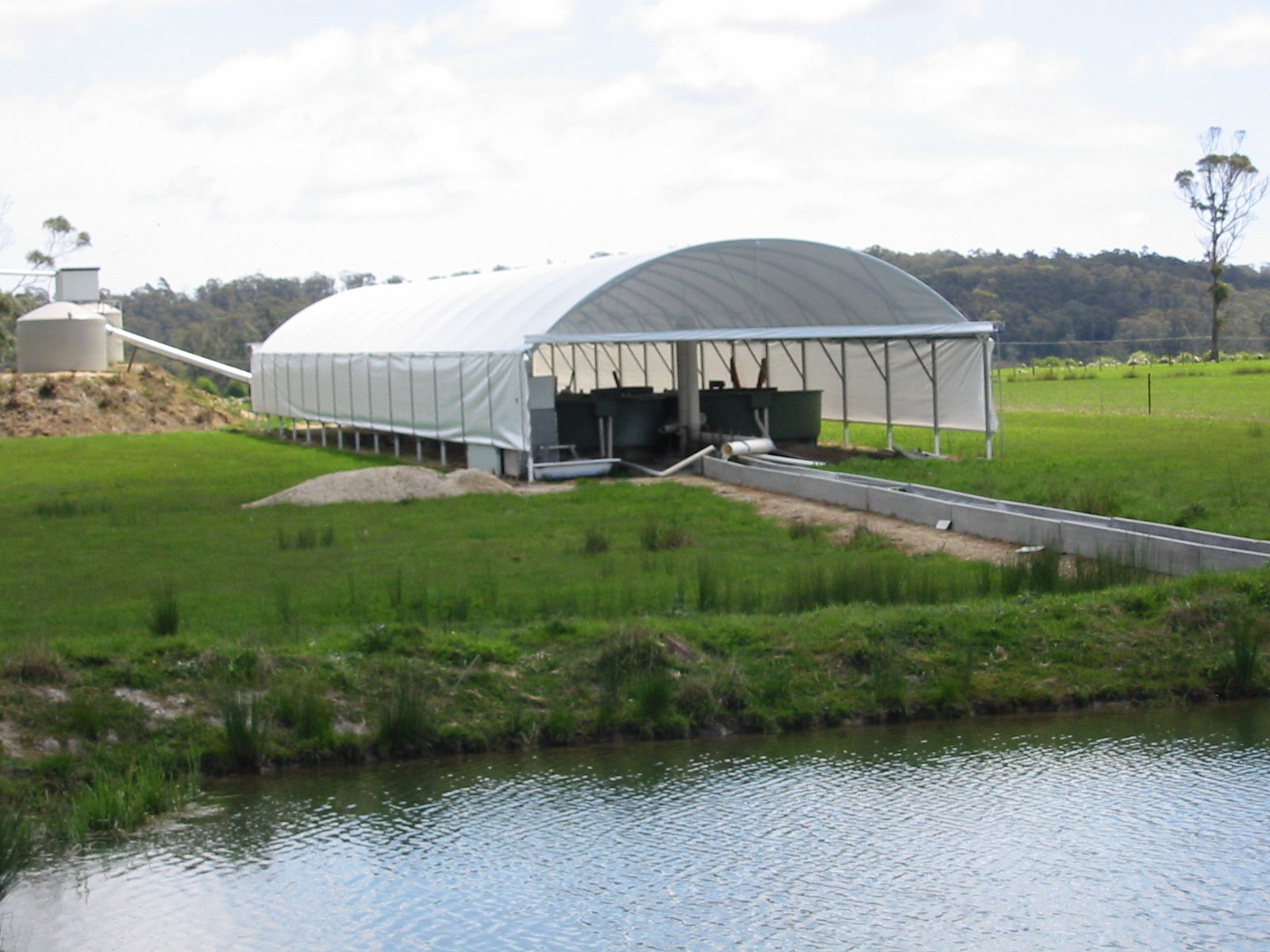 Distance view animal shelter surrounded by green grass